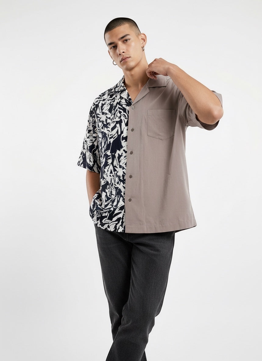 Atsignatsign Official unisex oversized Hawaiian shirt in taupe and navy with a contrasting abstract leaf print on the left side. Made from 100% rayon.